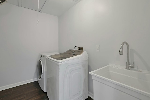 laundry room featuring washer and clothes dryer, dark wood finished floors, attic access, laundry area, and a sink