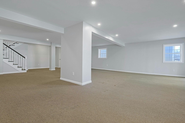 below grade area with recessed lighting, carpet, stairs, and baseboards