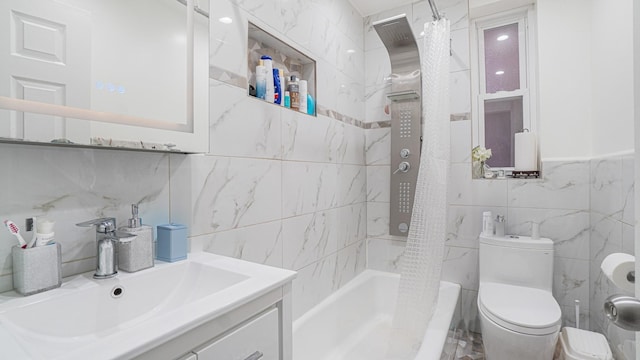 full bathroom featuring vanity, toilet, tile walls, and shower / bath combo