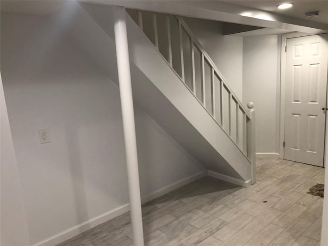 stairway with hardwood / wood-style floors