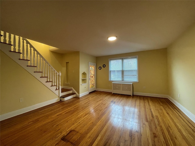 64-18 84th Pl, Middle Village, NY 11379 - entrance foyer with radiator, wood finished floors, stairway, and baseboards