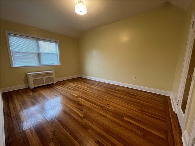 64-18 84th Pl, Middle Village, NY 11379 - spare room with radiator heating unit, dark wood finished floors, and baseboards