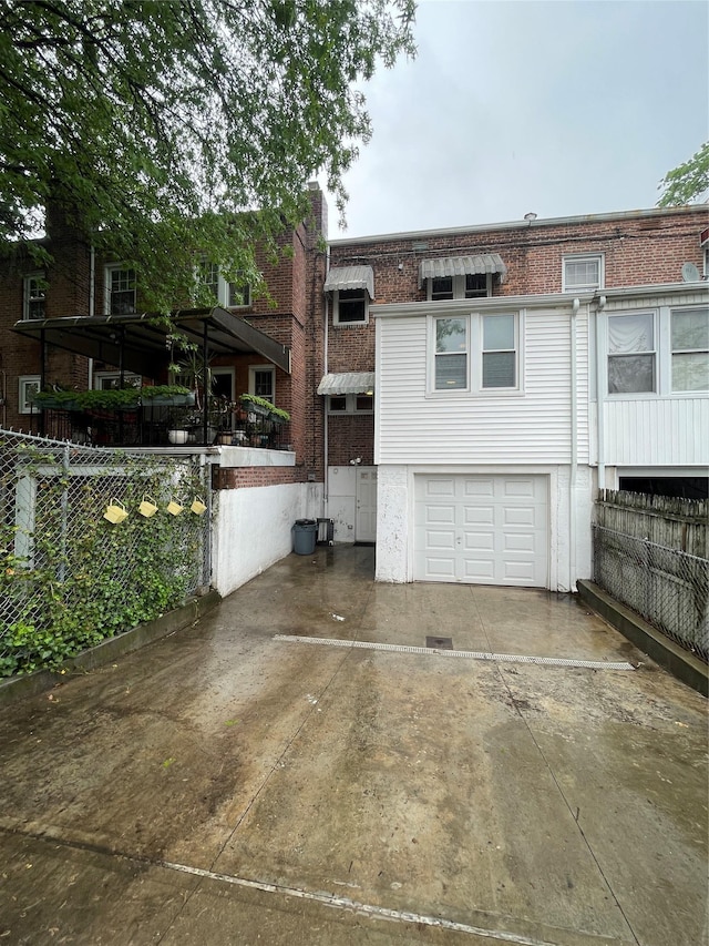 64-18 84th Pl, Middle Village, NY 11379 - back of property with a garage, fence, and driveway