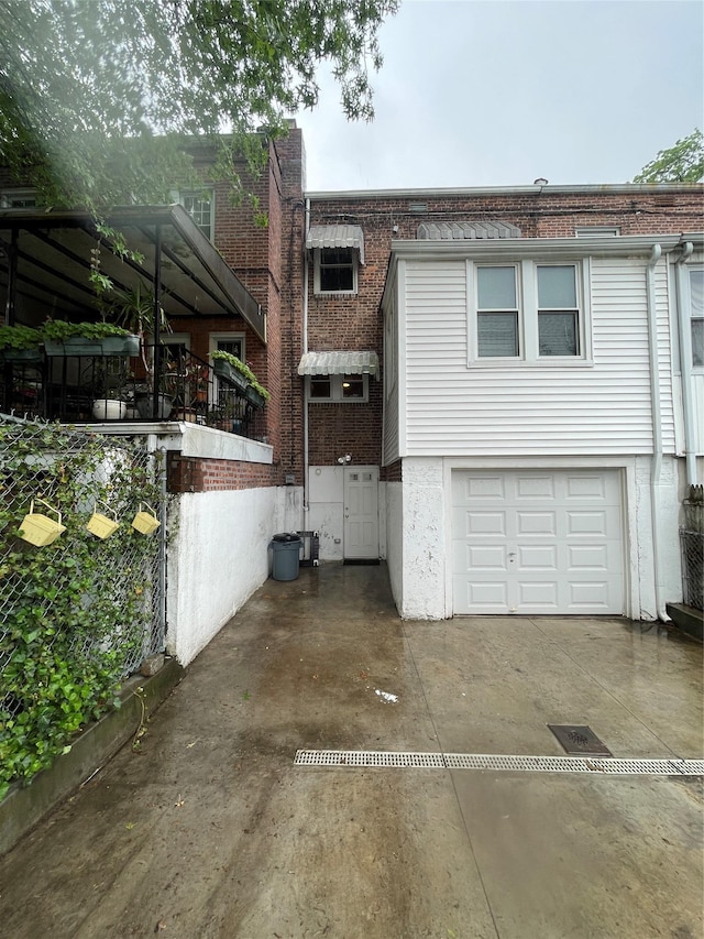 64-18 84th Pl, Middle Village, NY 11379 - view of front of house featuring a garage, brick siding, and driveway