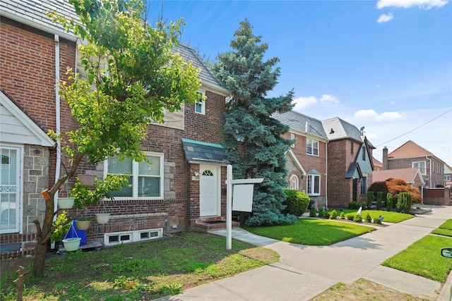 64-18 84th Pl, Middle Village, NY 11379 - view of front of house with a front yard, brick siding, entry steps, a high end roof, and a residential view