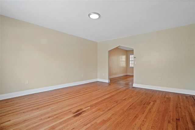 64-18 84th Pl, Middle Village, NY 11379 - empty room featuring light wood-style flooring and arched walkways