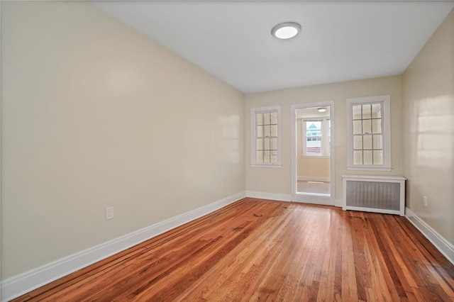 64-18 84th Pl, Middle Village, NY 11379 - unfurnished room with radiator and hardwood / wood-style flooring