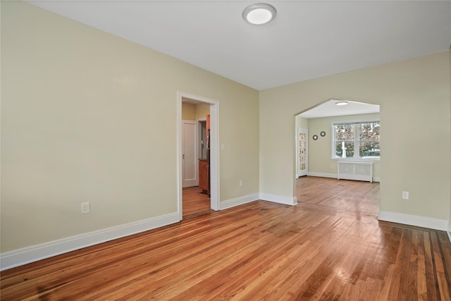 64-18 84th Pl, Middle Village, NY 11379 - spare room featuring radiator and wood finished floors