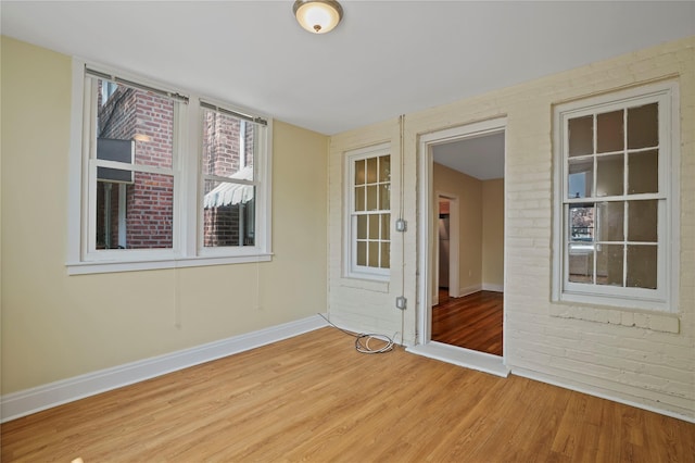 64-18 84th Pl, Middle Village, NY 11379 - empty room featuring wood finished floors and brick wall