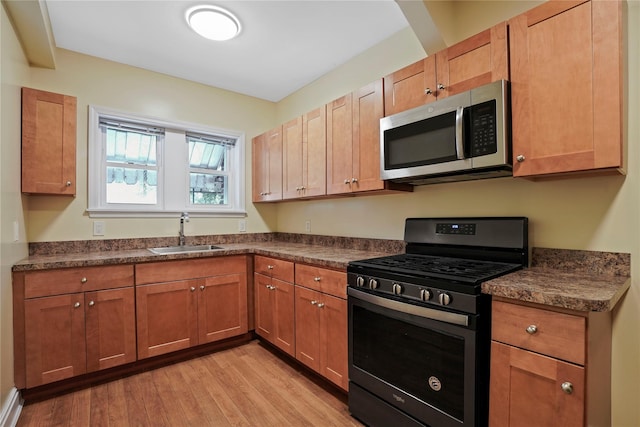 64-18 84th Pl, Middle Village, NY 11379 - kitchen with appliances with stainless steel finishes, dark countertops, and light wood-style flooring
