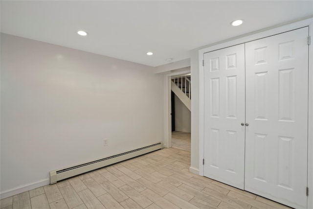 64-18 84th Pl, Middle Village, NY 11379 - unfurnished bedroom with a baseboard heating unit, light wood-type flooring, recessed lighting, and a closet