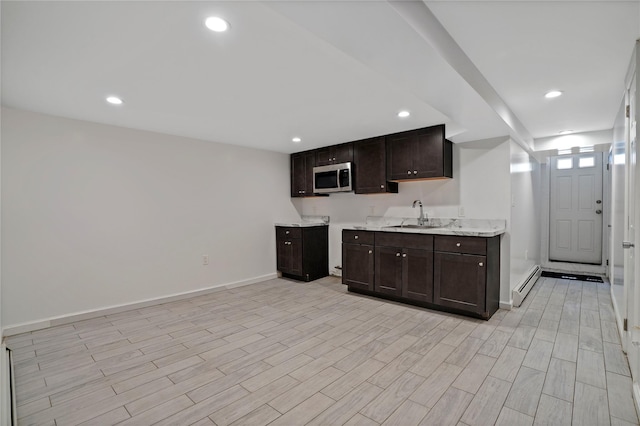 64-18 84th Pl, Middle Village, NY 11379 - kitchen featuring stainless steel microwave, a baseboard radiator, dark brown cabinetry, light wood-style floors, and recessed lighting