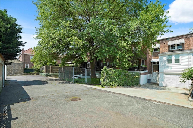 64-18 84th Pl, Middle Village, NY 11379 - view of front of house featuring driveway and a garage
