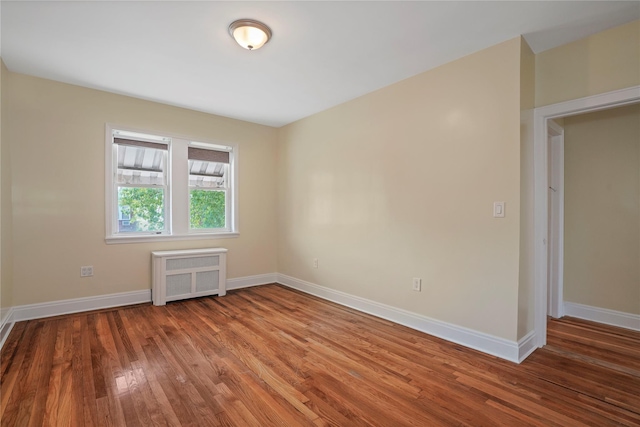 64-18 84th Pl, Middle Village, NY 11379 - spare room featuring radiator heating unit and wood finished floors