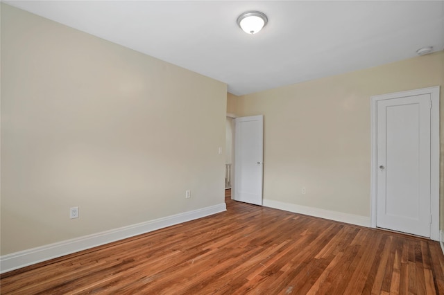 64-18 84th Pl, Middle Village, NY 11379 - unfurnished bedroom with wood finished floors and baseboards