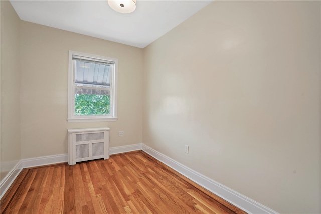 64-18 84th Pl, Middle Village, NY 11379 - unfurnished room with radiator and light wood finished floors