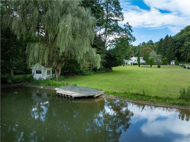 view of dock featuring a water view and a lawn