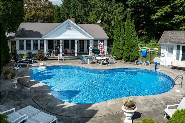 view of pool featuring a patio and an outdoor structure