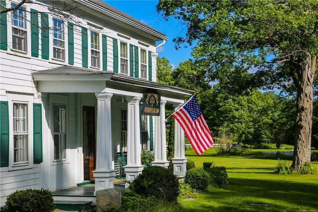 entrance to property featuring a lawn