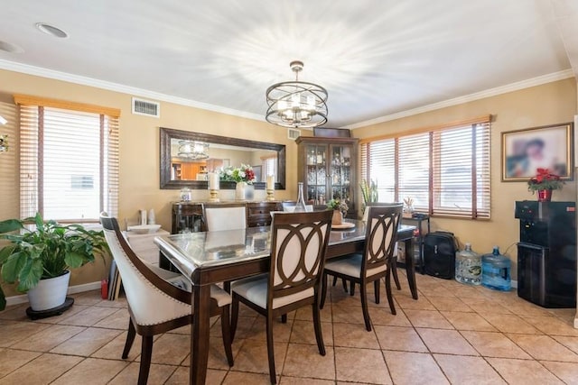 tiled dining area with ornamental molding and a notable chandelier