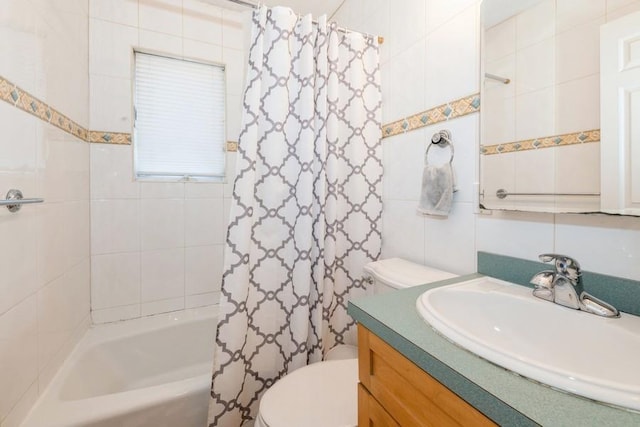 full bathroom featuring vanity, shower / bath combo, toilet, and tile walls