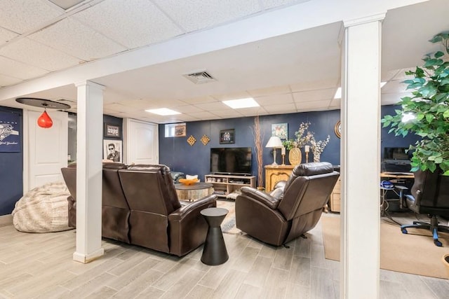 living room featuring a paneled ceiling