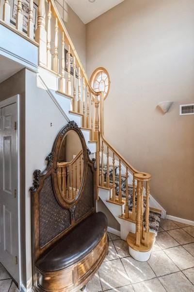 stairway featuring tile patterned floors