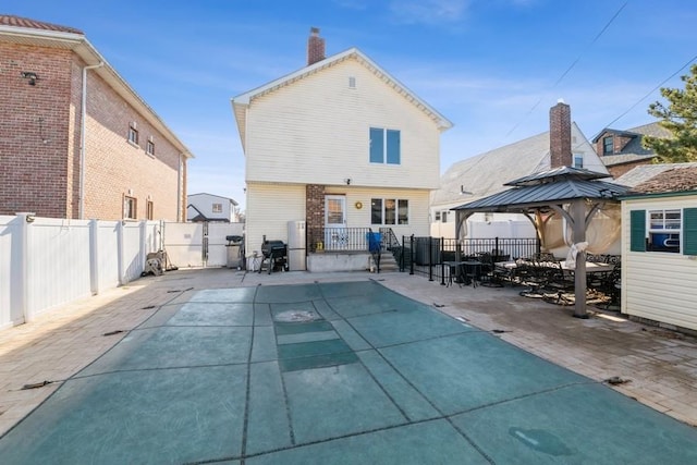 rear view of property with a gazebo and a patio area