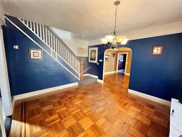 unfurnished dining area with parquet flooring and a chandelier