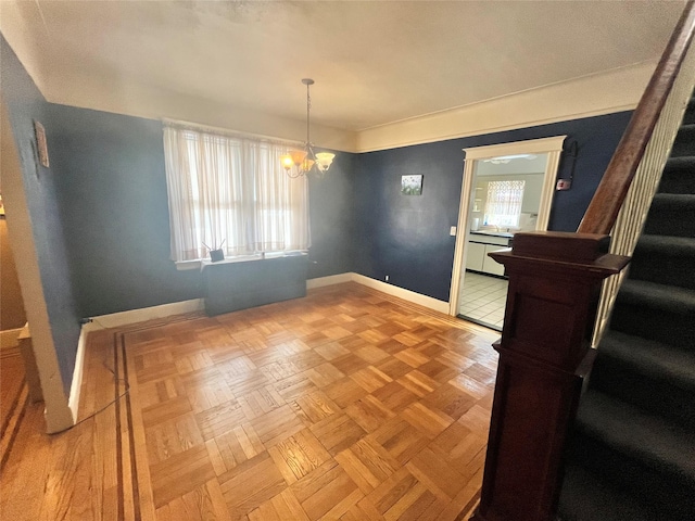 dining area featuring an inviting chandelier and parquet flooring