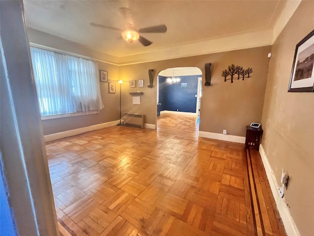 unfurnished room featuring radiator, light parquet floors, and ceiling fan