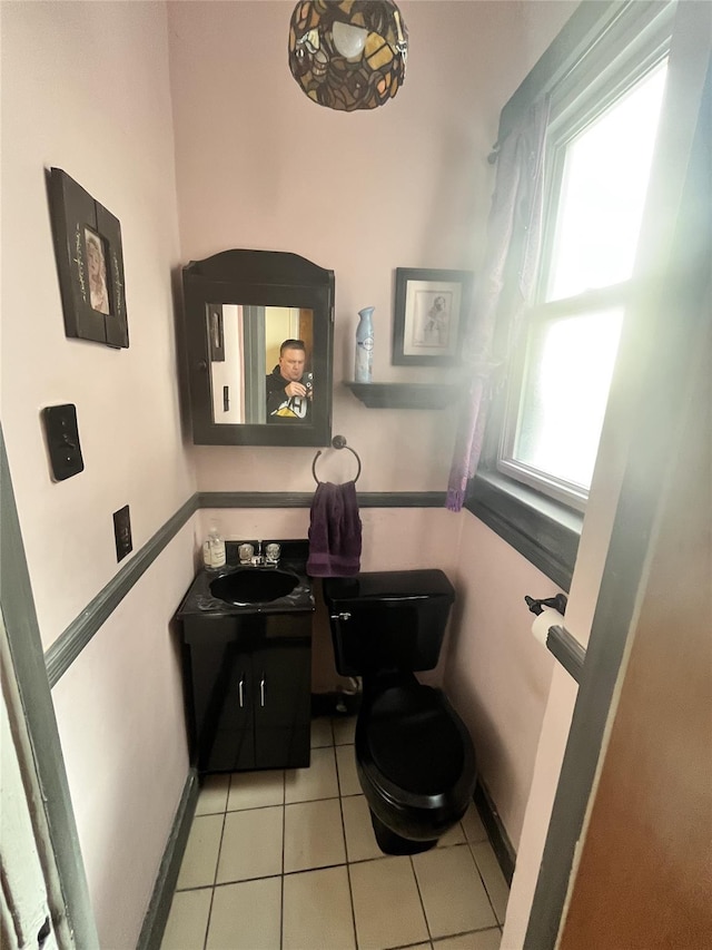 bathroom featuring vanity, tile patterned floors, and toilet