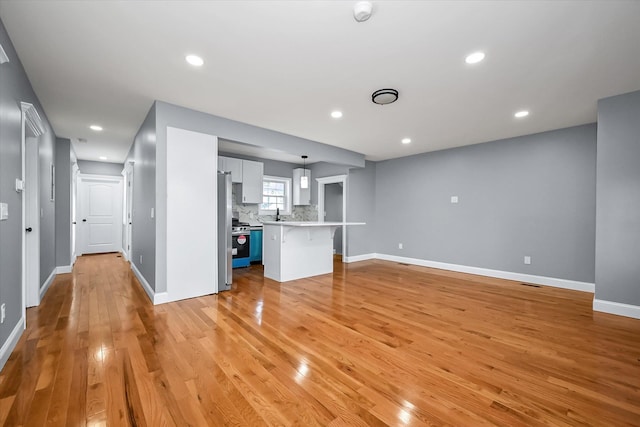 unfurnished living room with light hardwood / wood-style flooring