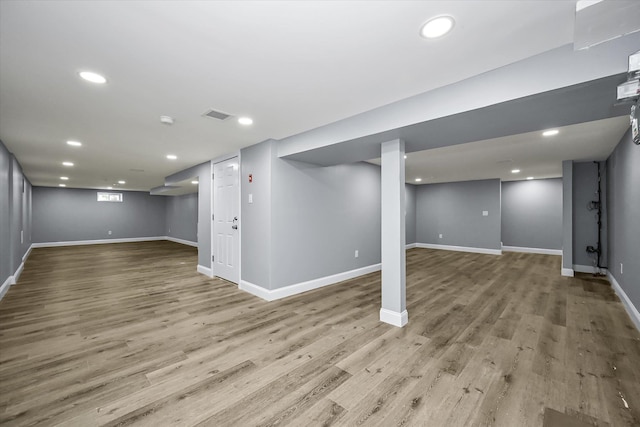 basement with light hardwood / wood-style floors