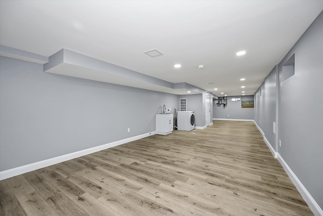 basement with independent washer and dryer and light wood-type flooring