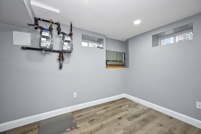 basement with hardwood / wood-style flooring