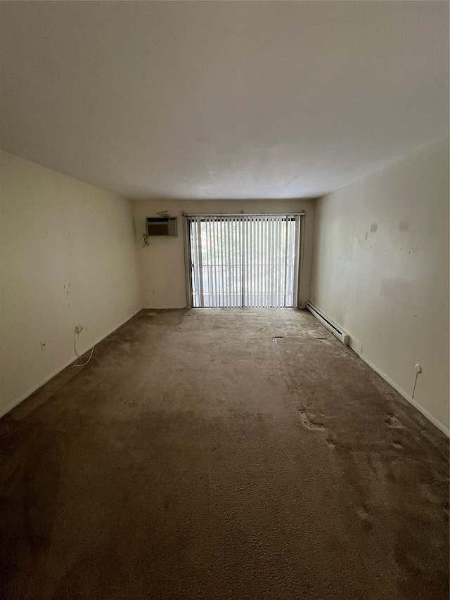 empty room with a baseboard heating unit, carpet floors, and an AC wall unit