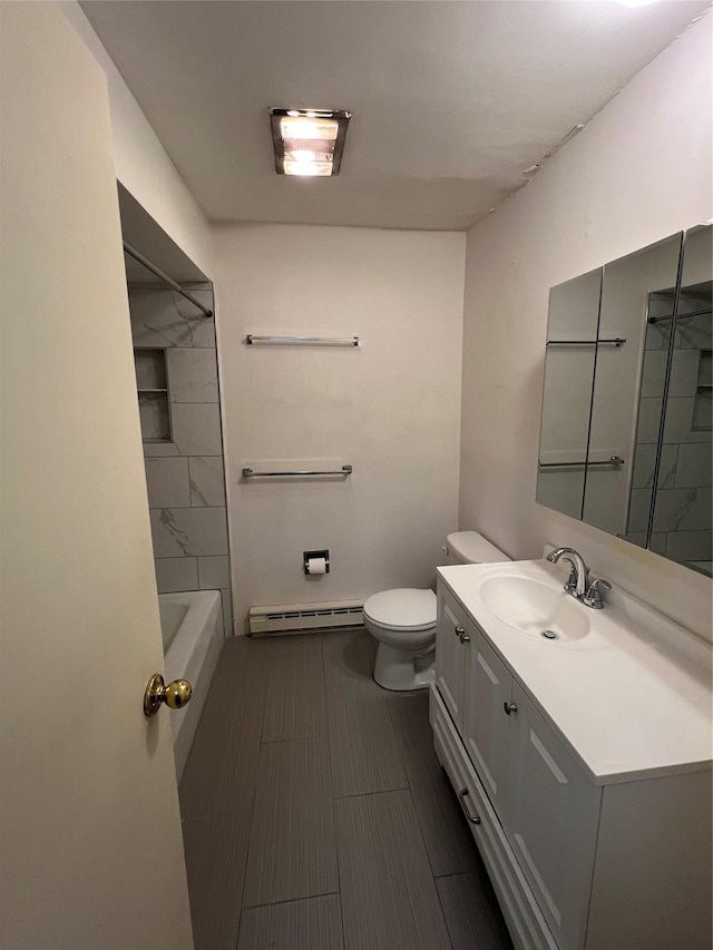 bathroom with a baseboard radiator, vanity, and toilet