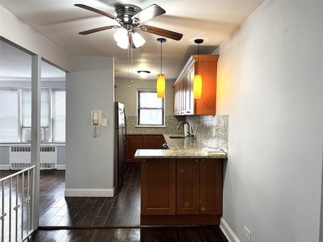 143-50 Hoover Ave Unit 204, Briarwood, NY 11435 - kitchen featuring a sink, freestanding refrigerator, radiator, decorative backsplash, and dark wood-style flooring