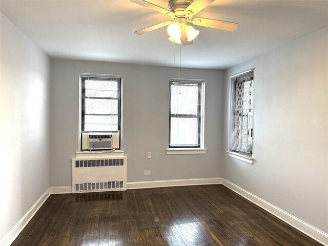 143-50 Hoover Ave Unit 204, Briarwood, NY 11435 - spare room featuring cooling unit, a healthy amount of sunlight, dark wood-style flooring, and radiator heating unit