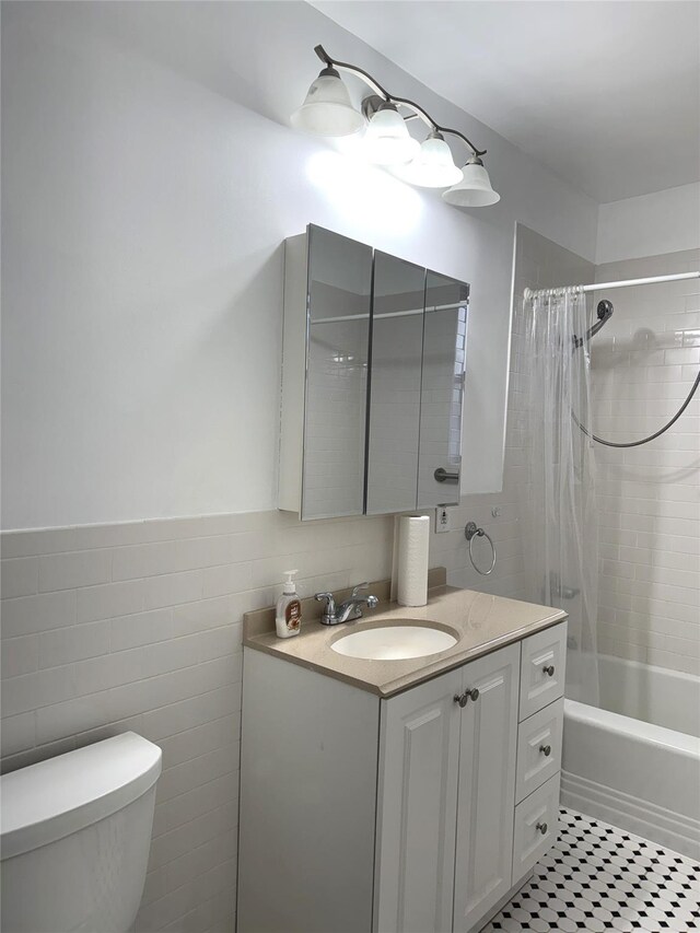 143-50 Hoover Ave Unit 204, Briarwood, NY 11435 - full bathroom featuring shower / tub combo, toilet, tile walls, and vanity
