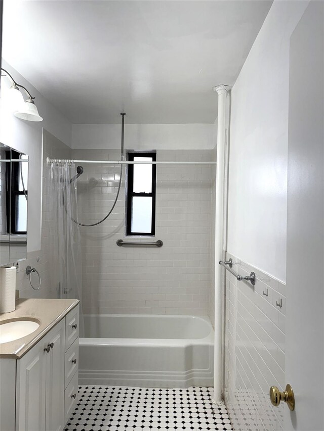 143-50 Hoover Ave Unit 204, Briarwood, NY 11435 - full bath with vanity, wainscoting, tile patterned floors, shower / bath combination with curtain, and tile walls