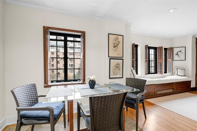 dining room featuring wood-type flooring and ornamental molding