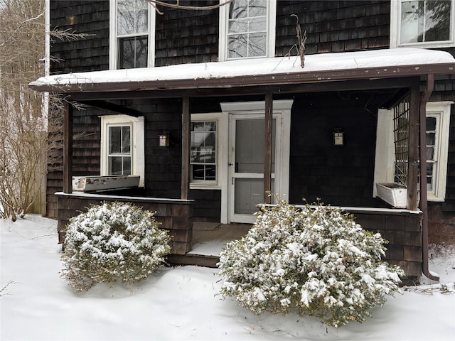 view of snow covered property entrance