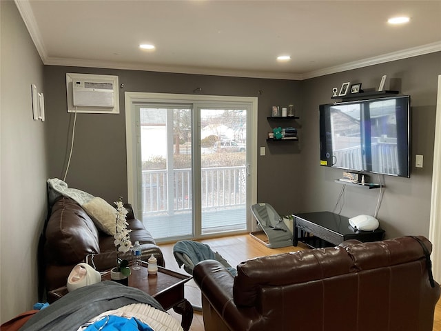 living room with ornamental molding, a wall mounted AC, and light hardwood / wood-style floors