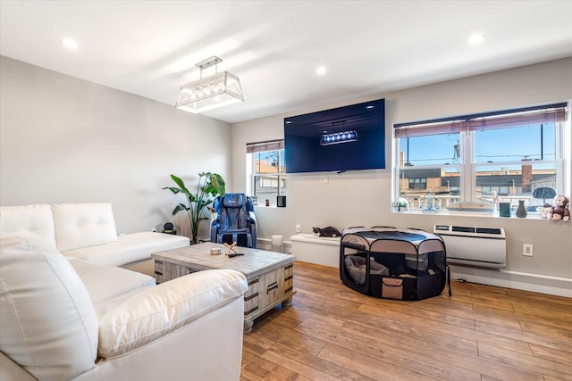 living room with hardwood / wood-style flooring and heating unit