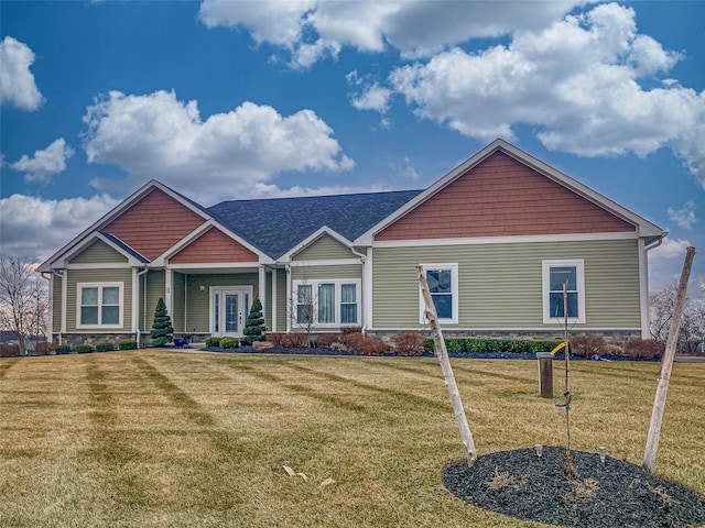 view of front of home with a front lawn and french doors