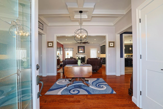 entryway with coffered ceiling, a notable chandelier, beamed ceiling, dark wood-type flooring, and crown molding