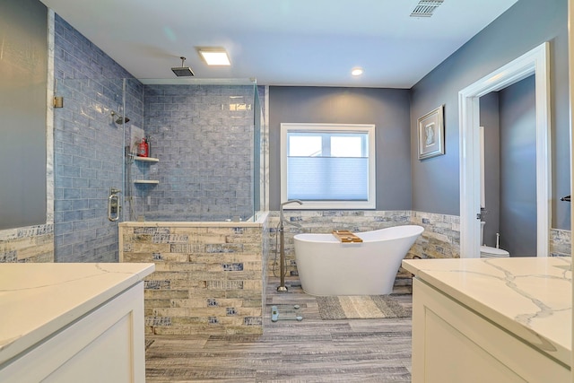 bathroom featuring tile walls, vanity, independent shower and bath, and hardwood / wood-style flooring