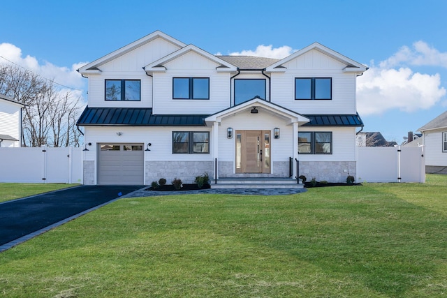 modern farmhouse featuring a garage and a front lawn